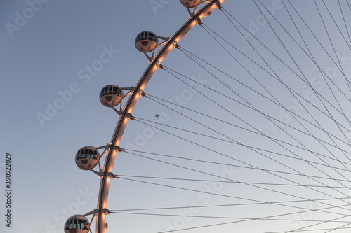 Photography Closeup shot of the High Roller observation wheel in Las Vegas with an airplanei