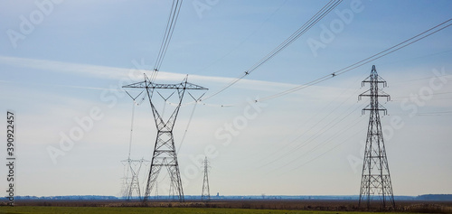Fotografie, Obraz Farmland after plowing with electric pylon in Quebec, Canada