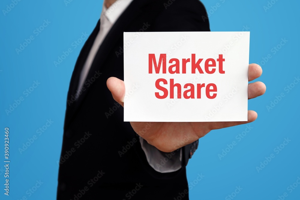 Market Share. Businessman in suit showing business card with text. Man isolated on blue background Market Share. Businessman in suit showing business card with text. Man isolated on blue background