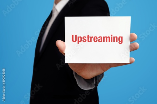 Upstreaming. Businessman in suit showing business card with text. Man isolated on blue background photo