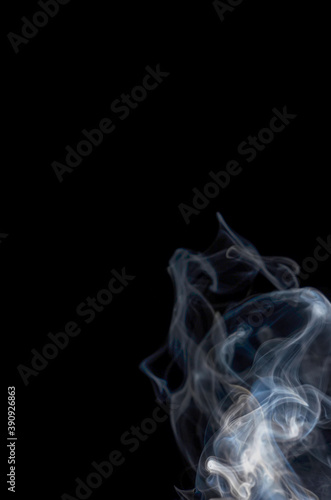 Smoke streaming on a black background close-up