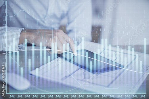 Double exposure of man s hands holding and using a digital device and forex graph drawing. Financial market concept.