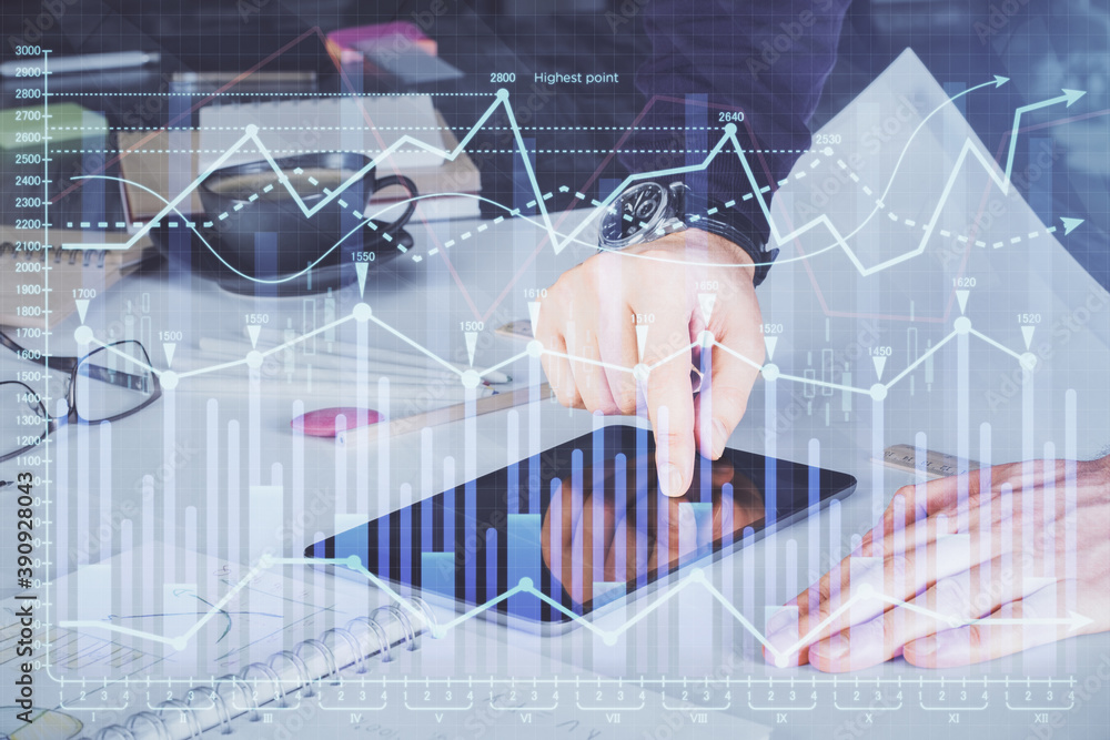 Double exposure of man's hands holding and using a digital device and forex graph drawing. Financial market concept. Double exposure of man's hands holding and using a digital device and forex graph drawing. Financial market concept.