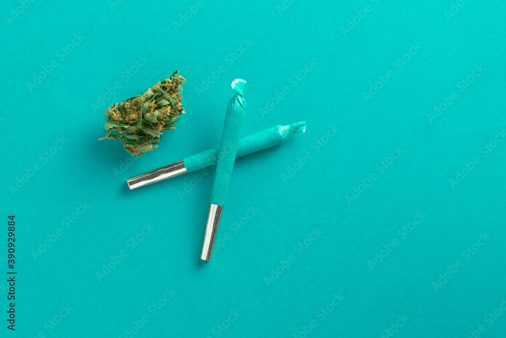 Cool blue cannabis joints overhead with marijuana bud. Winter or spring colour. - obrazy, fototapety, plakaty 
