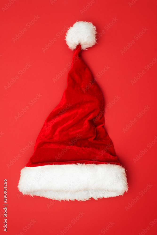 Christmas concert, Christmas hat on a red background, top view, copy space Christmas concert, Christmas hat on a red background, top view, copy space