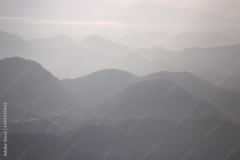 layers of mountains with fog