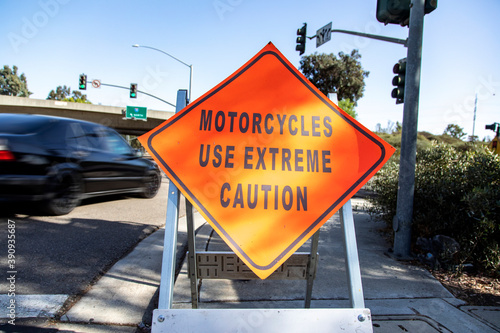 A diamond shaped road sign advising motorcyle riders to use extreme caution
