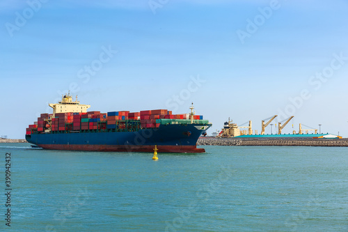 container ship loaded with containers enters the Harbor