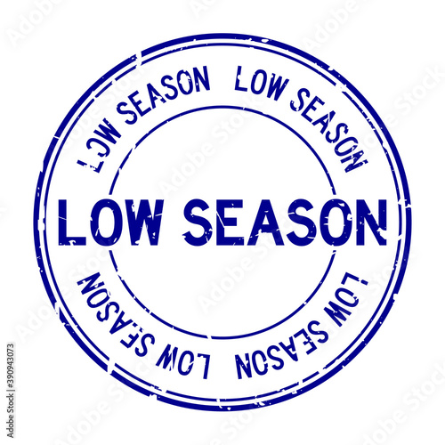 Grunge blue low season word round rubber seal stamp on white background