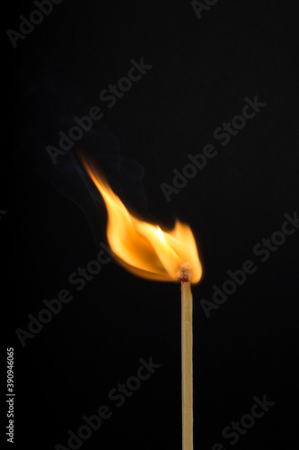 burning match on black background © violet5885