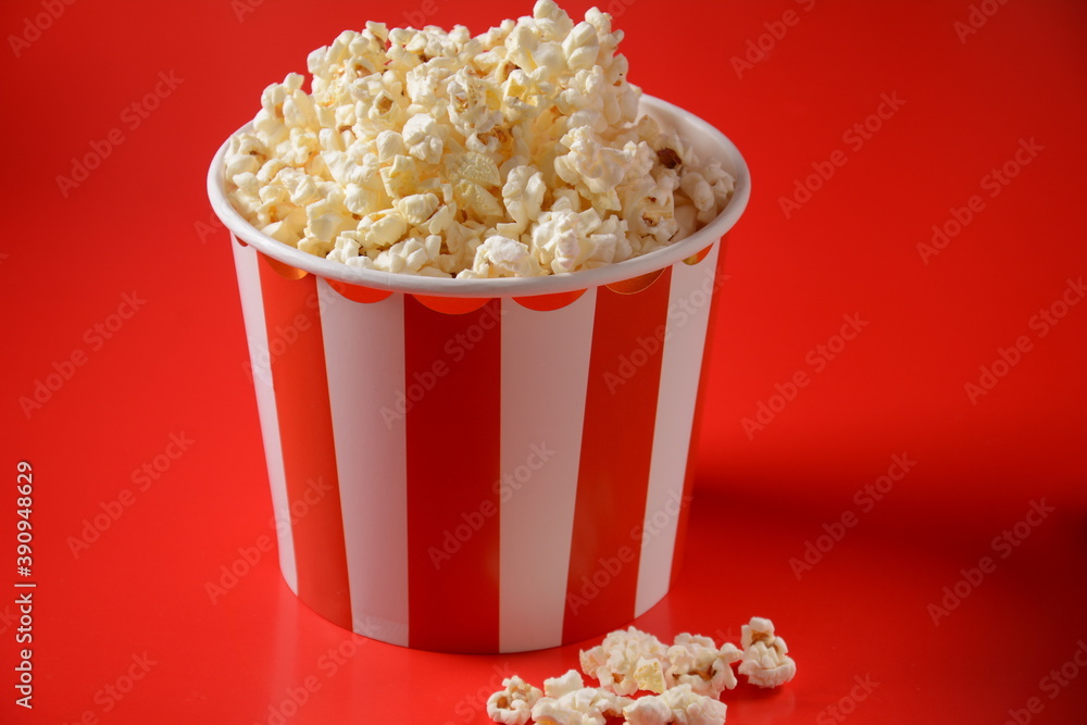 Buckets with delicious popcorn on red background Buckets with delicious popcorn on red background
