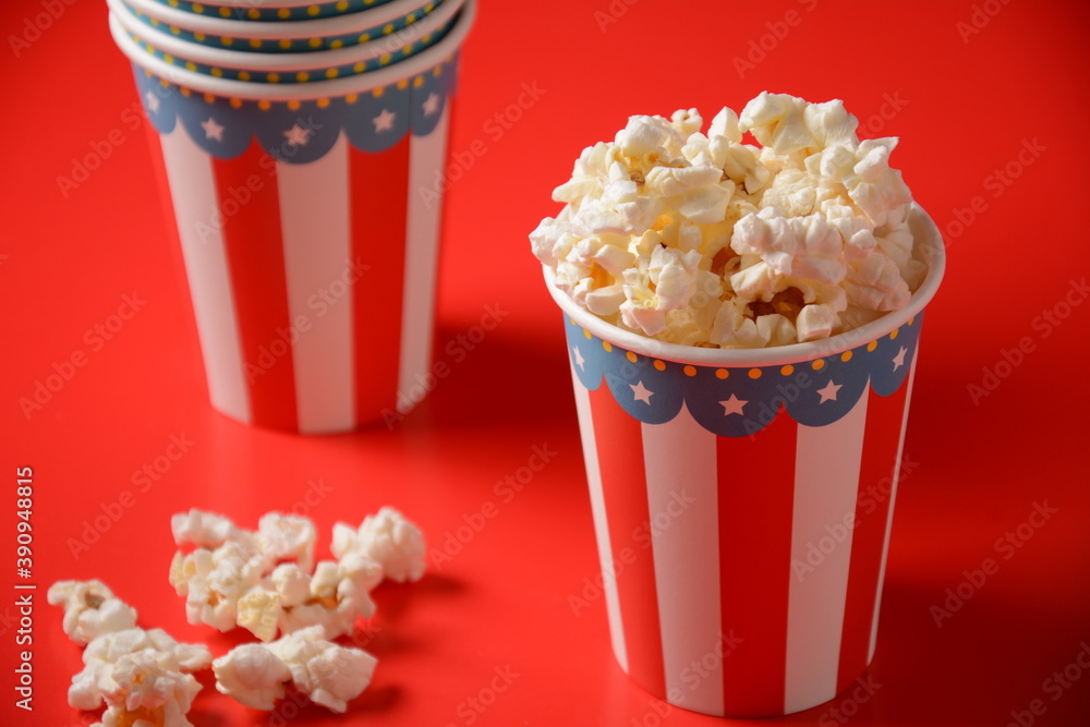 Buckets with delicious popcorn on red background 