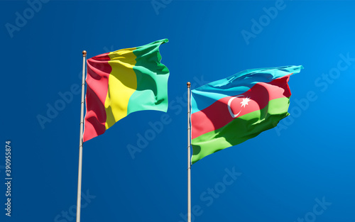 Beautiful national state flags of Guinea and Azerbaijan together at the sky background. 3D artwork concept.
