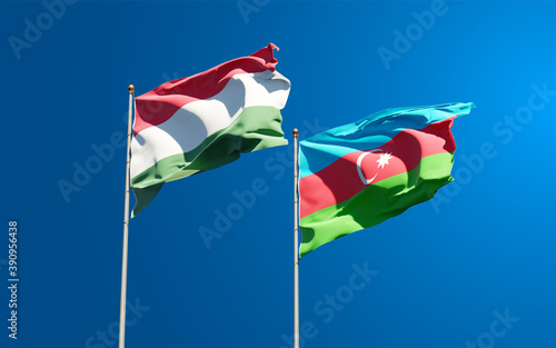 Beautiful national state flags of Hungary and Azerbaijan together at the sky background. 3D artwork concept.