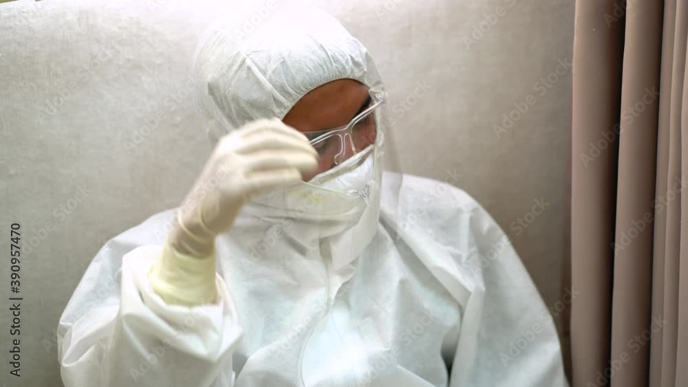 Asian Doctor and medical technicians in protective disease PPE suit uniform and face mask sad, tire and despair. Medical staff in clean suit. Asian Doctor and medical technicians in protective disease PPE suit uniform and face mask sad, tire and despair. Medical staff in clean suit.