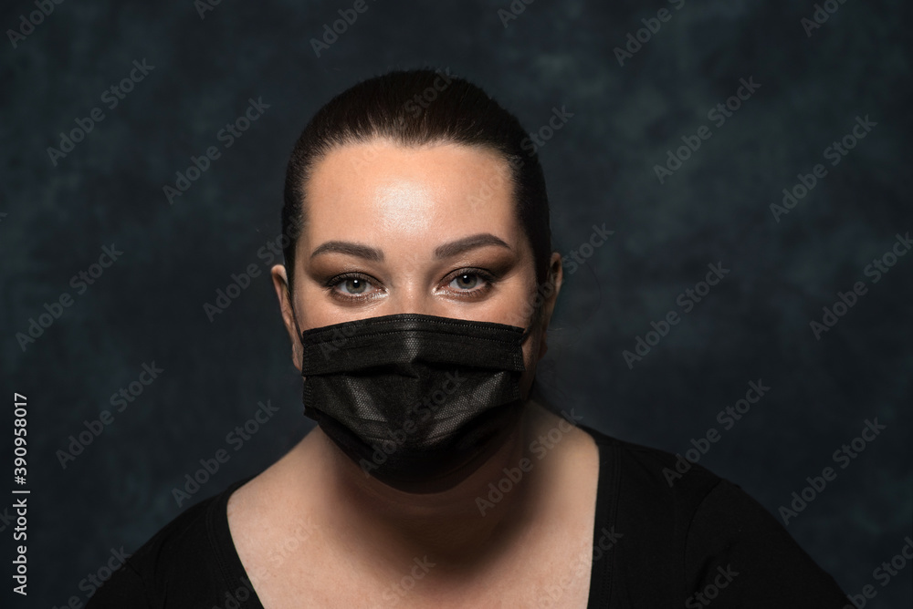 portrait of a beautiful woman in a black mask on a dark background portrait of a beautiful woman in a black mask on a dark background