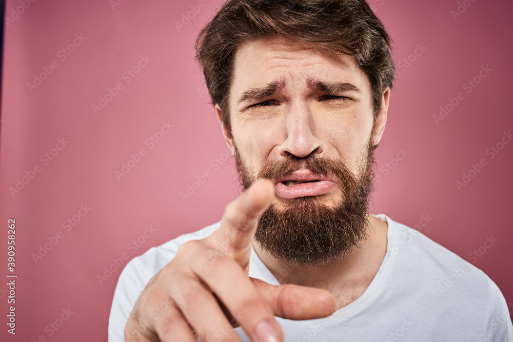 bearded man in white t-shirt emotions displeased facial expression studio pink background bearded man in white t-shirt emotions displeased facial expression studio pink background