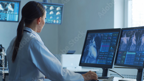 Professional medical doctors are maksing computer research in hospital office. Medicine, healthcare and cardiology concepts.