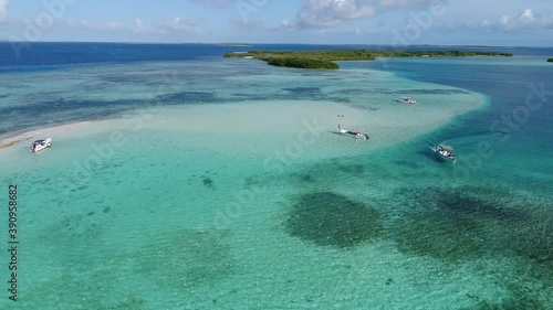 aerial view tracking right  carenero island In Los Roques, Venezuela in a paradisiac blue water  beach photo