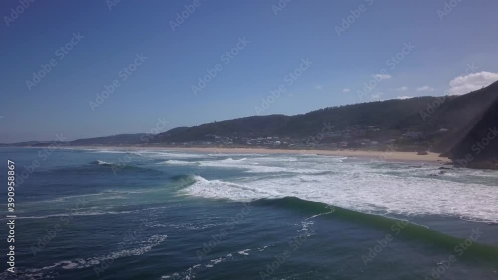 Aerial push in on a beach town in the sun Aerial push in on a beach town in the sun