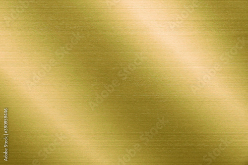 Gold metal texture of brushed stainless steel plate with the reflection of light.