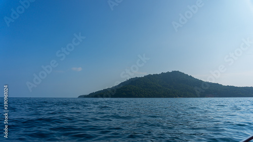 Beautiful paradise of tropical island in Terengganu. Scenic view of vast blue crystal clear ocean against blue sky with clouds on summer day. Perfect landscape background for relaxing vacation.