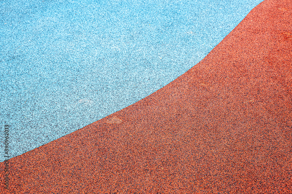 Fototapeta premium red carpet texture. close up of red and blue bouncy floor in child's playground, with drying water.