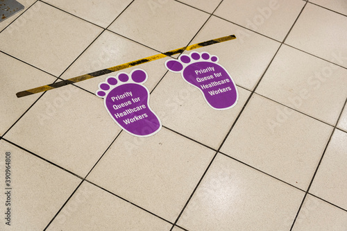 Dirty and Used Purple Floor Sticker Indicating Priority Queue for Healthcare Workers