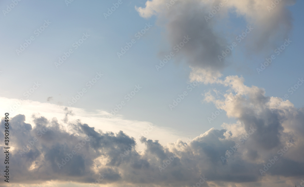 Beautiful blue sky with clouds and sun behind them. Beautiful blue sky with clouds and sun behind them.