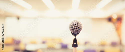 Public speaking backgrounds, Close-up the microphone on stand for speaker speech at seminar room with blur bokeh background.