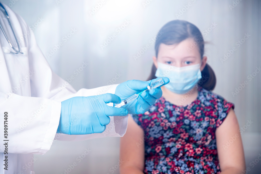 Vaccination concept. Male doctor vaccinating cute little girl in clinic. Vaccination concept. Male doctor vaccinating cute little girl in clinic.
