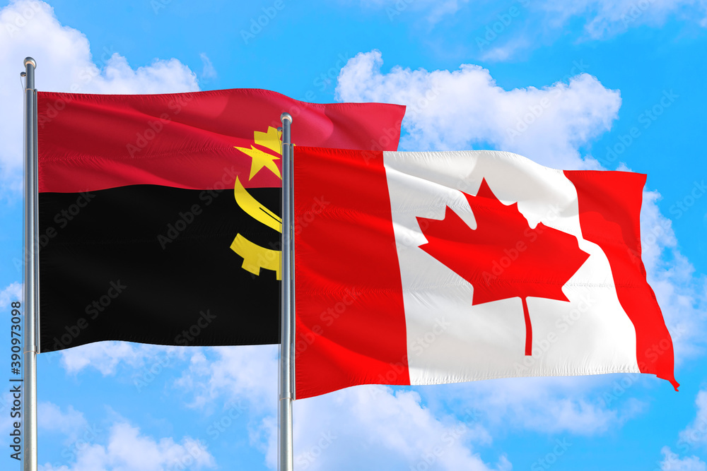 Canada and Angola national flag waving in the windy deep blue sky. Diplomacy and international relations concept. Canada and Angola national flag waving in the windy deep blue sky. Diplomacy and international relations concept.