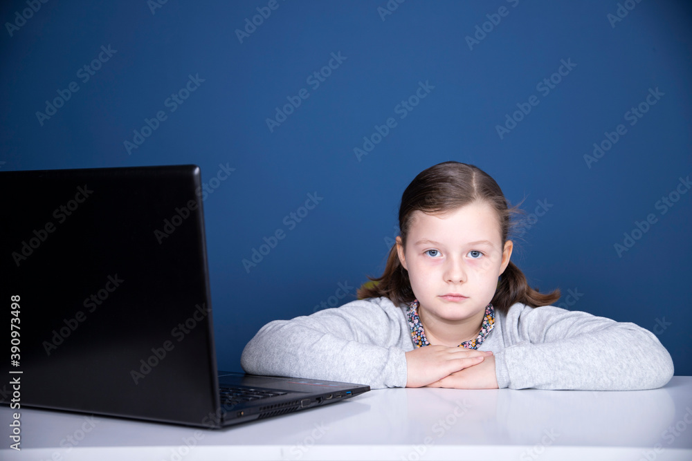 Study online with video call teacher. Young girl learn online and looking at laptop at home.Social distancing. Study online with video call teacher. Young girl learn online and looking at laptop at home.Social distancing.