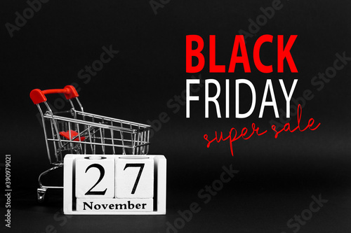 The calendar is November 27, and shopping cart on a black background, the concept layout to Black Friday, advertisement banner, promotion inscription.