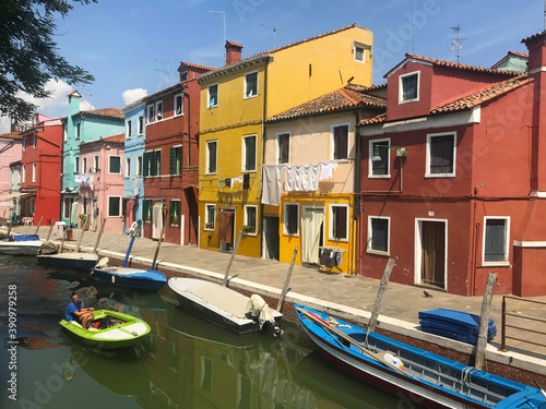 Burano island canal and colorful houses with boats in Venice Italy © April Wong