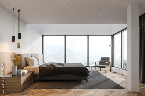 White master bedroom interior with bed and armchair