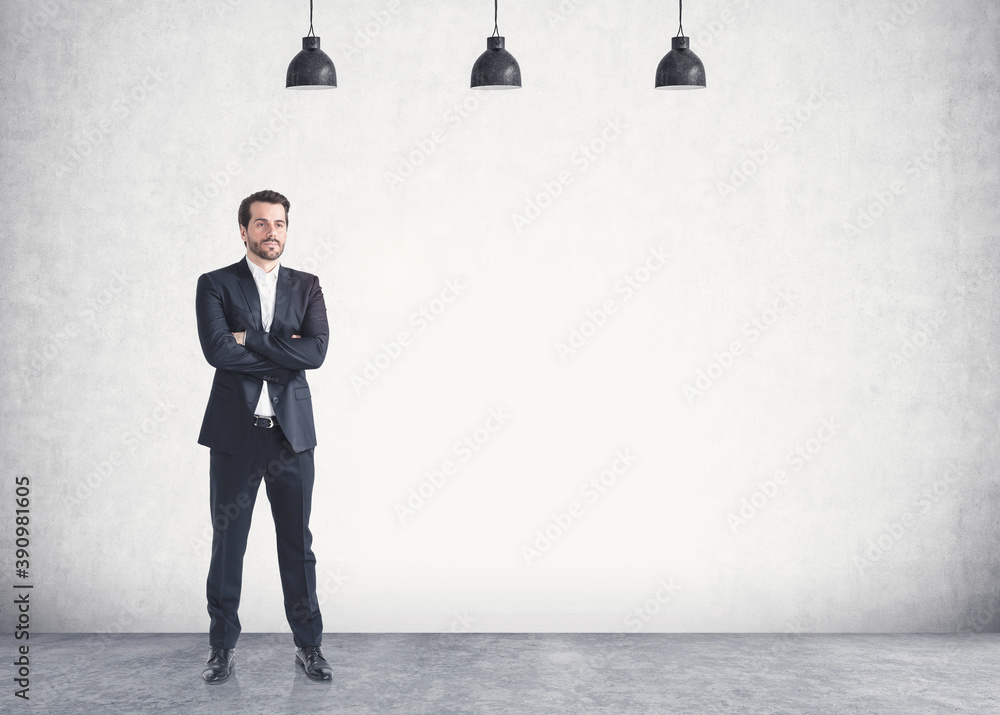 Fototapeta premium Confident young businessman with crossed arms, mock up
