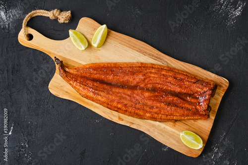 Top view of smoked eel on wooden cutting board