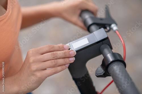Close up picture of human hand pressing buttins on a handlebar