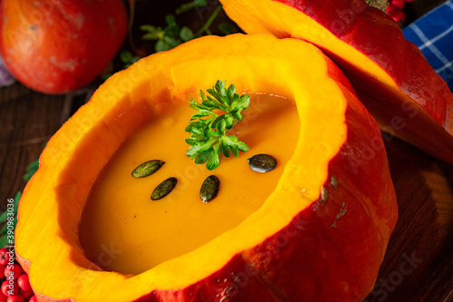 Delicious autumn pumpkin soup with baguette photo