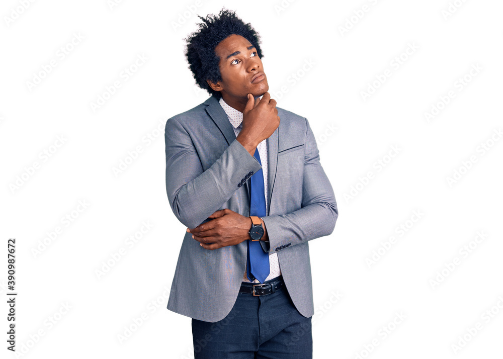 Handsome african american man with afro hair wearing business jacket with hand on chin thinking about question, pensive expression. smiling with thoughtful face. doubt concept. Handsome african american man with afro hair wearing business jacket with hand on chin thinking about question, pensive expression. smiling with thoughtful face. doubt concept.