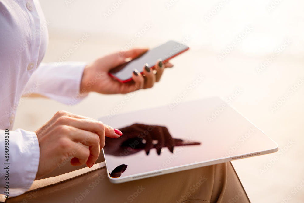 Woman using tech gadgets outdoors Woman using tech gadgets outdoors