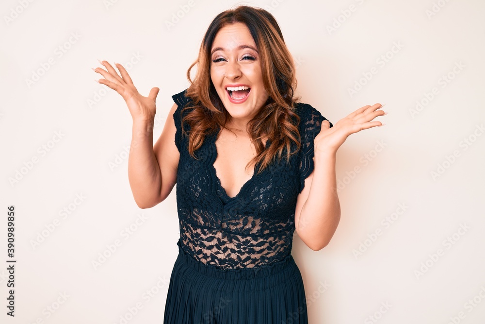 Young beautiful caucasian woman wearing elegant clothes celebrating victory with happy smile and winner expression with raised hands Young beautiful caucasian woman wearing elegant clothes celebrating victory with happy smile and winner expression with raised hands