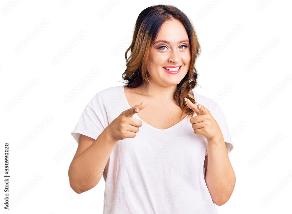 Young beautiful caucasian woman wearing casual white tshirt pointing fingers to camera with happy and funny face. good energy and vibes. Young beautiful caucasian woman wearing casual white tshirt pointing fingers to camera with happy and funny face. good energy and vibes.