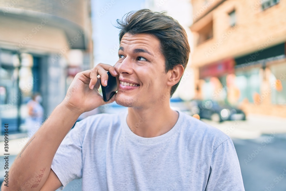 Young caucasian man smiling happy talking on the smartphone at the city. Young caucasian man smiling happy talking on the smartphone at the city.