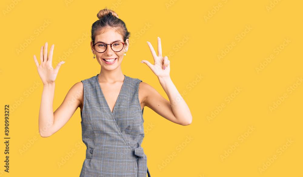 Beautiful caucasian woman with blonde hair wearing business clothes and glasses showing and pointing up with fingers number eight while smiling confident and happy.