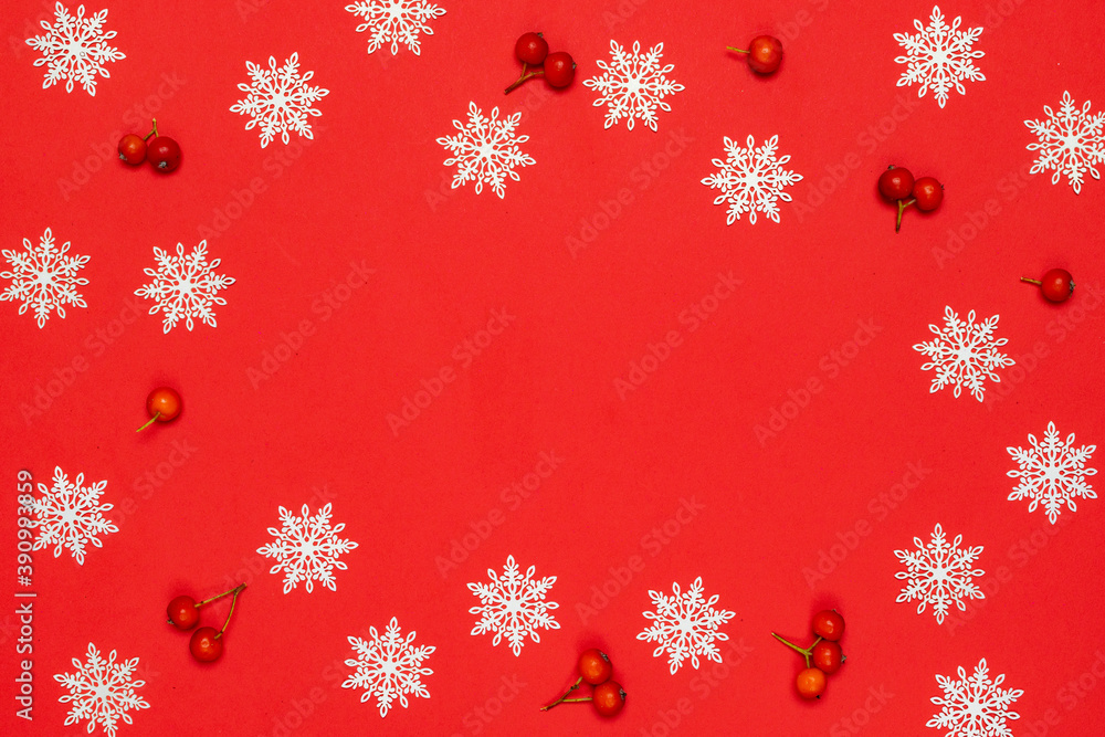 Xmas pattern. White snowflakes, red berry in Christmas composition on red background for greeting card. Flat lay, top view, copy space. Xmas pattern. White snowflakes, red berry in Christmas composition on red background for greeting card. Flat lay, top view, copy space.