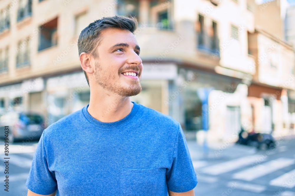 Young caucasian man smiling happy walking at the city. Young caucasian man smiling happy walking at the city.