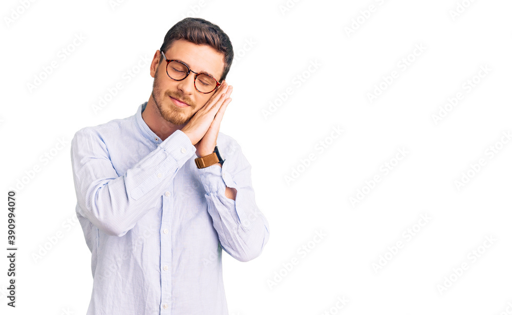 Handsome young man with bear wearing elegant business shirt and glasses sleeping tired dreaming and posing with hands together while smiling with closed eyes. Handsome young man with bear wearing elegant business shirt and glasses sleeping tired dreaming and posing with hands together while smiling with closed eyes.