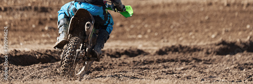 Racer child on motorcycle participates in motocross race, active extreme sport